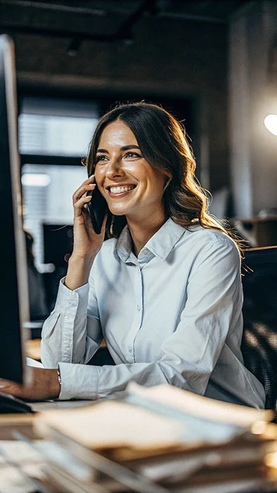 Happy female accountant on the phone